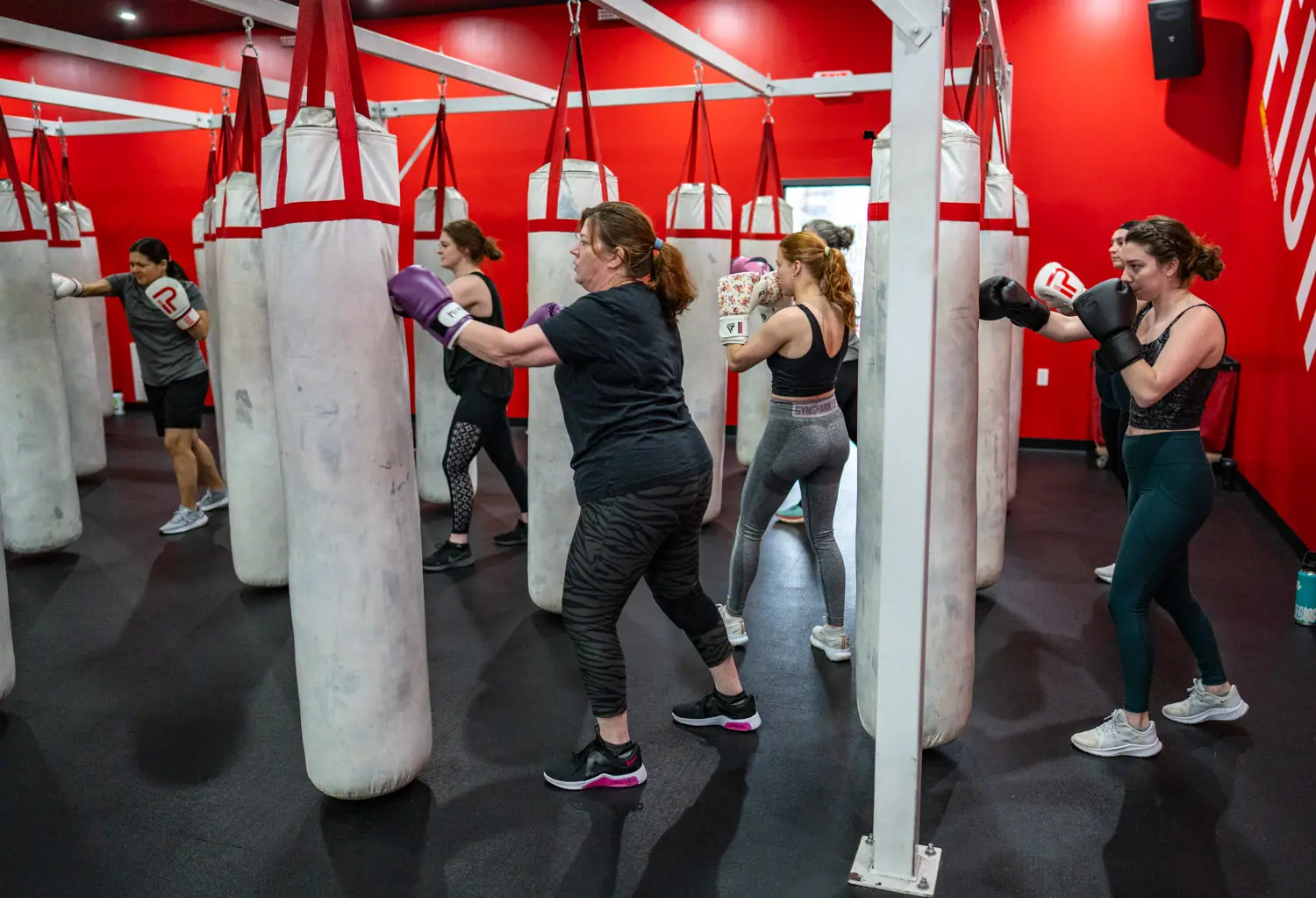 Members training on heavy bags during a PUNCH cardio boxing class