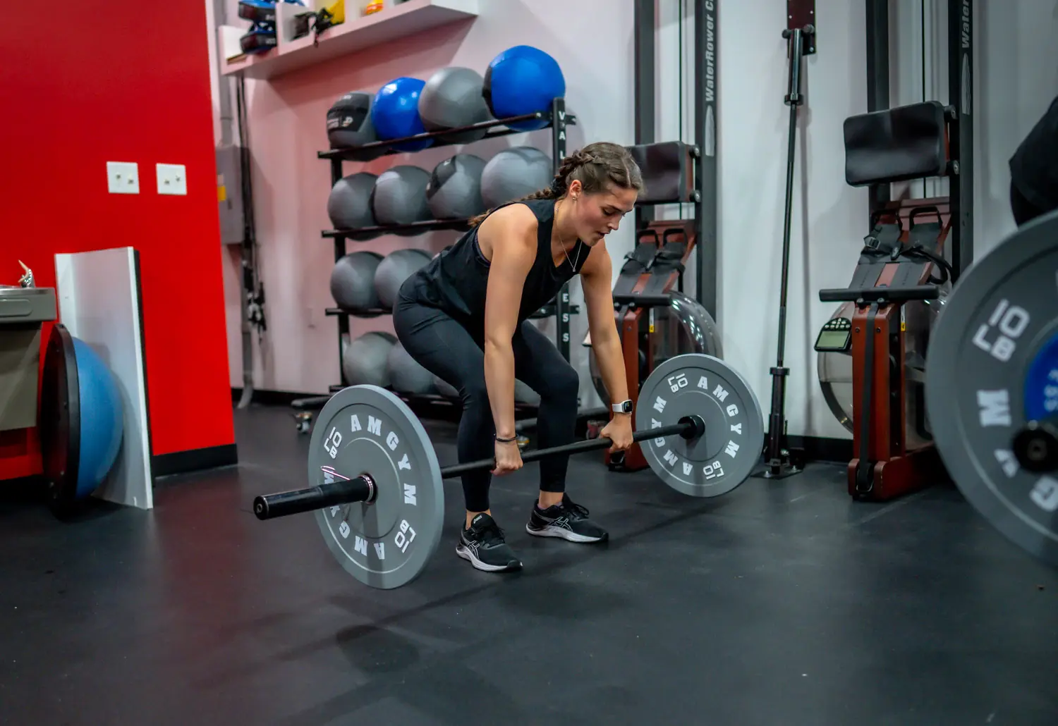 Member strength training with a barbell at PUNCH